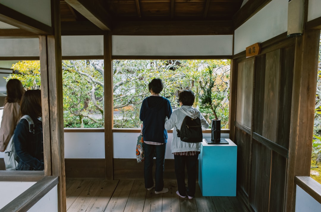 People touring a home, looking out a window